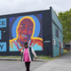 A woman walks past a mural honoring Manuel “Manny” Ellis, Thursday, May 27, 2021, in the Hilltop neighborhood of Tacoma, Wash., south of Seattle. Ellis died on March 3, 2020 after he was restrained by police officers. Earlier in the day Thursday, the Washington state attorney general filed criminal charges against three police officers in the death of Ellis, who told the Tacoma officers who were restraining him he couldn’t breathe before he died.